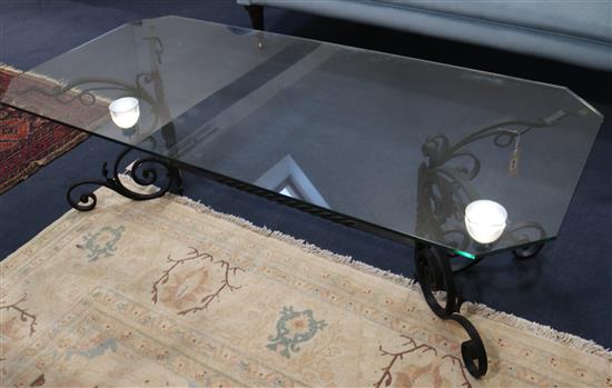 A wrought iron coffee table with plate glass top, W.150cm